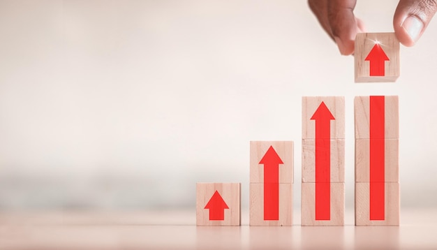 Ladder career path for business growth success process concept.Hand arranging wood block stacking as step stair with arrow up