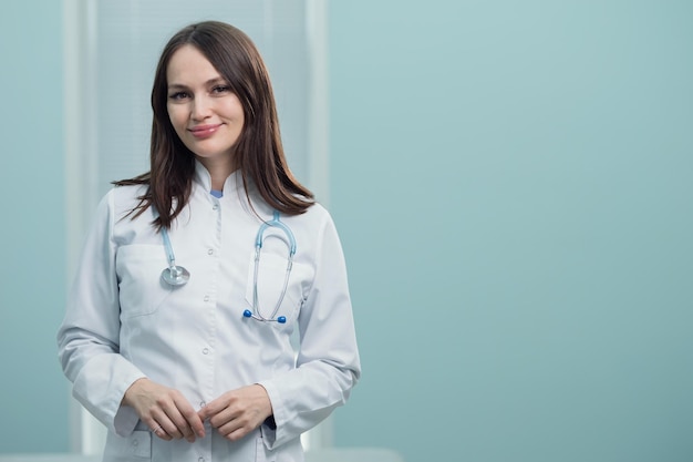 Lady doctor with stethoscope rejoices at end of working day