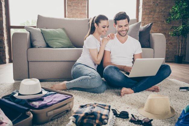 lady guy couple stay home together packing stuff planning trip