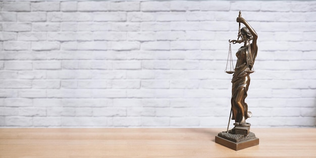 Lady Justice or Justitia statue on desk legal law jurisdiction