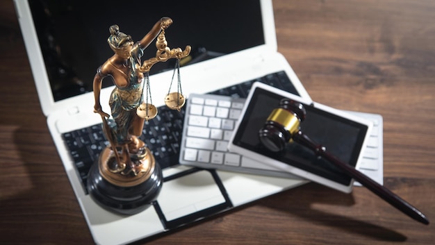 Lady Justice Statue with a judge gavel tablet and computer