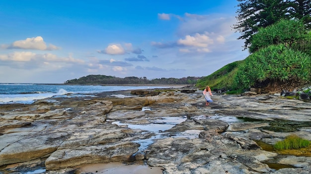 Lady Looking Out to Sea from the Rocks at Yamba NSW Australia