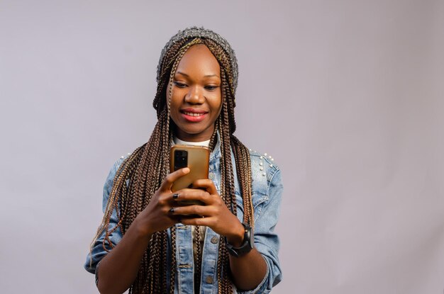 Lady smiling as she operates her phone