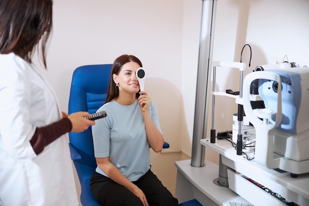 Lady using an occluder while checking her eyesight