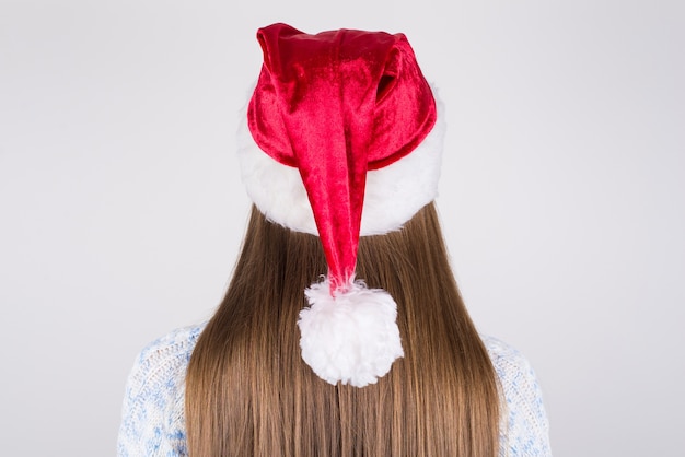 Lady with smooth silky hair wearing santa hat on head