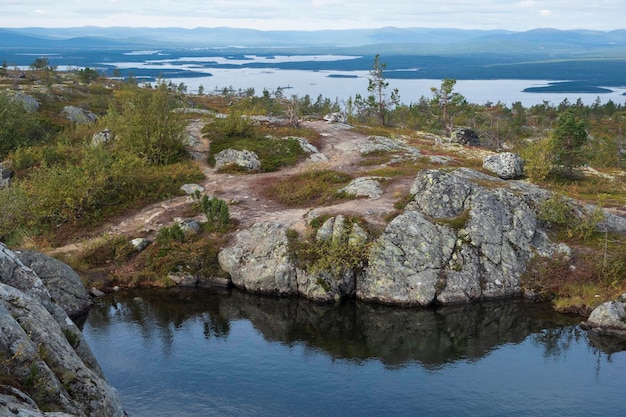 Lake beyond Arctic Circle on top of a hill in autumn Kandalaksha Kola Peninsula Volosyanaya Hill