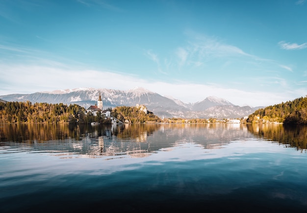 Lake Bled in the Alpine mountains in autumn under blue sky