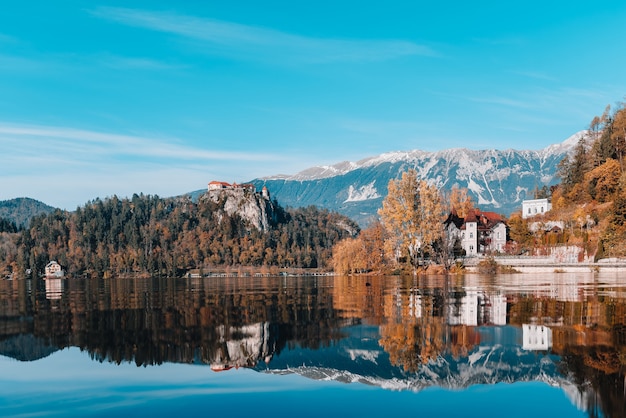 Lake Bled in the Alpine mountains in autumn under blue sky