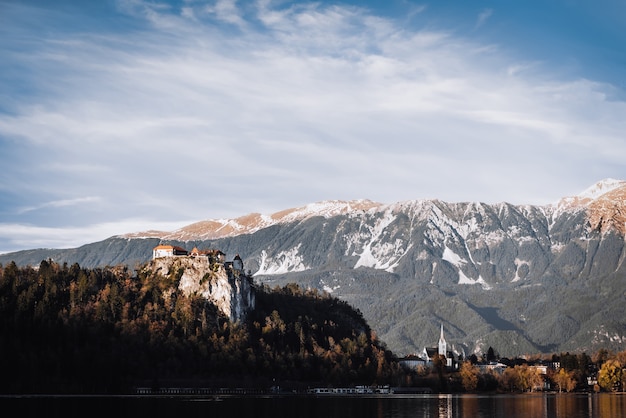 Lake Bled in the Alpine mountains in autumn under blue sky