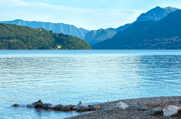 Lake Como (Italy) summer cloudy evening view with stony shore