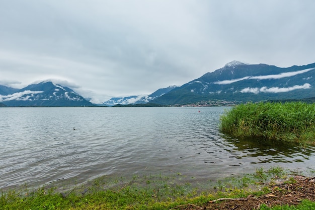 Lake Como (Italy) summer cloudy view with snow on mount top