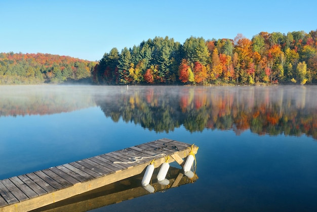 Lake fog with Autumn foliage and mountains with reflection in New England Stowe