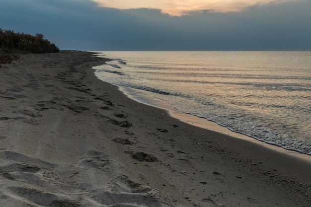 Lake issykkul kyrgyzstan empty sandy beach on the lake at dusk evening on the lake