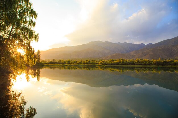 Lake in the mountains Beautiful nature reflection of clouds and mountains in blue water Kyrgyzstan Lake IssykKul