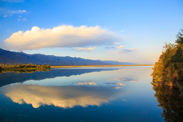 Lake in the mountains Beautiful nature reflection of clouds and mountains in blue water Kyrgyzstan Lake IssykKul