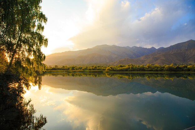 Lake in the mountains Quiet bay in the greenery at sunset Place for rest Kyrgyzstan Lake IssykKul