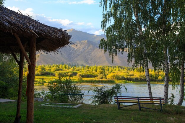 Lake in the mountains Quiet bay in the greenery at sunset Place for rest Kyrgyzstan Lake IssykKul