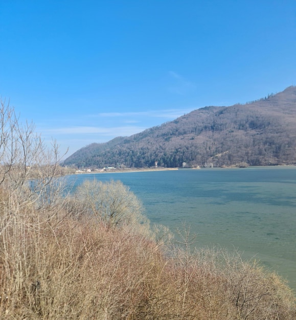 A lake in the mountains with a mountain in the background