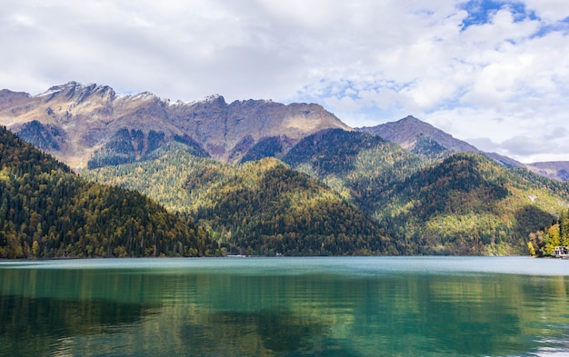 Lake Ritsa in Abkhazia in autumn, lake view with autumn forest in the background