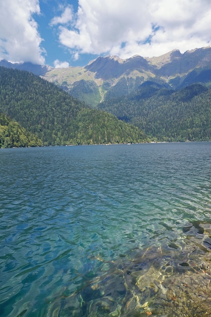 Lake Ritsa in mountains in Abkhazia in a summer sunny day.