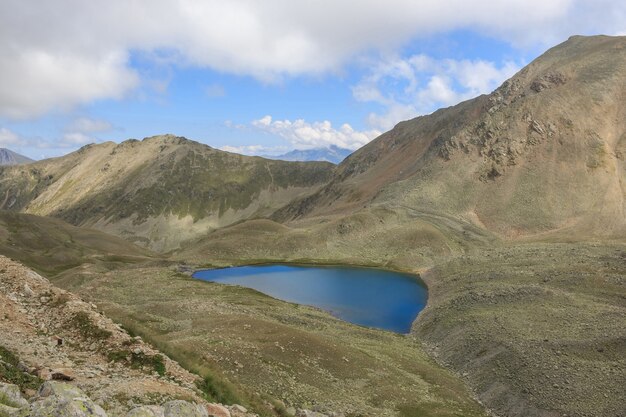 Lake scenes in mountains, national park Dombai, Caucasus, Russia, Europe. Summer landscape, sunshine weather, dramatic blue color sky and sunny day