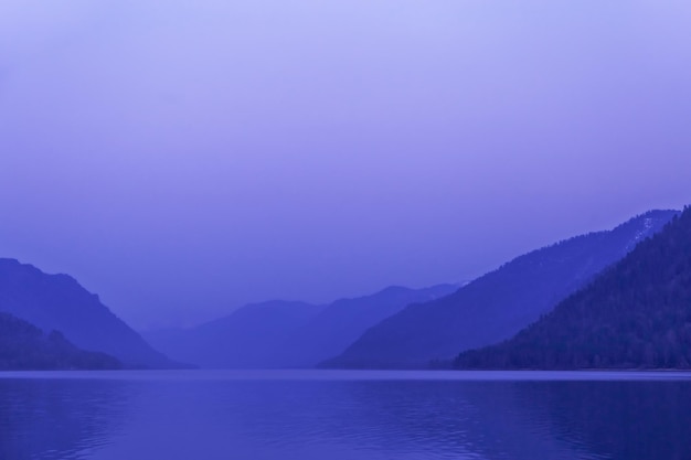 Lake Teletskoye Altai Republic Russia Blue clear sky and Mirror of lake Abstract panoramic landscape with natural gradient blue color nature environment scene monochrome background