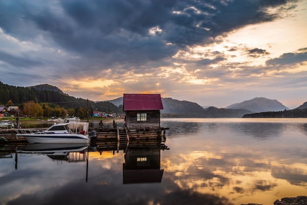 Lake wharf with a wooden pier at dawn. Teletskoye Lake, Artybash Village, Altai Republic, Russia