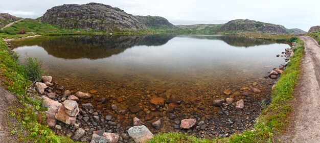 Lake with clean, fresh water on the shore of the Barents sea. Kola Peninsula , Russia.