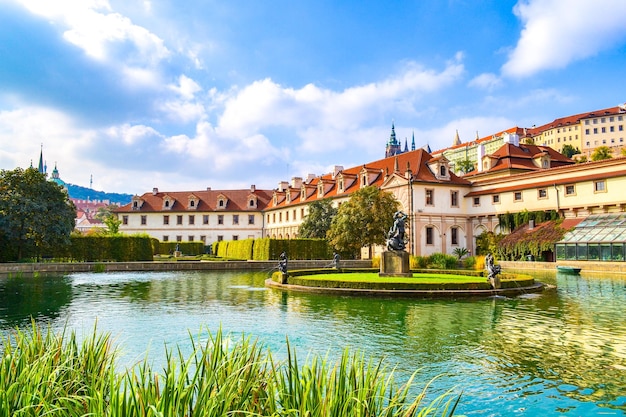 a lake with a lake and a building with a fountain in front of it Czech Republic Prague Sights