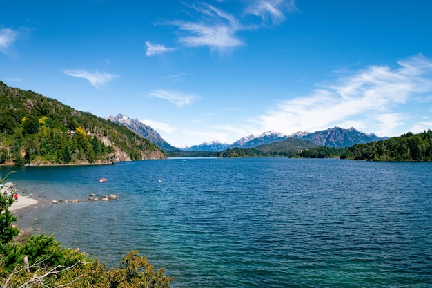 A lake with a mountain in the background and a kayak in the water