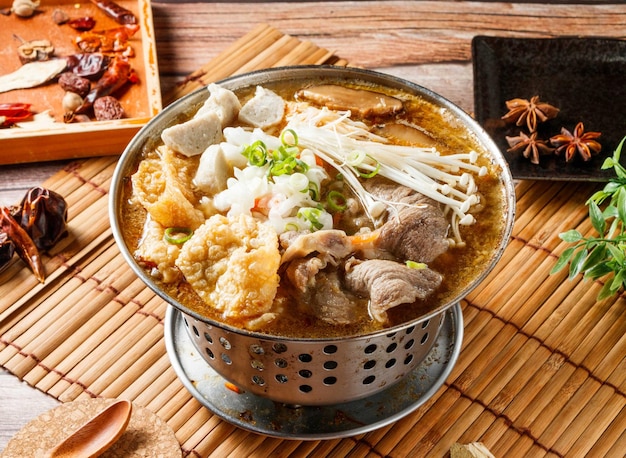 Lamb hot pot stew with red chili isolated on mat side view of japanese food