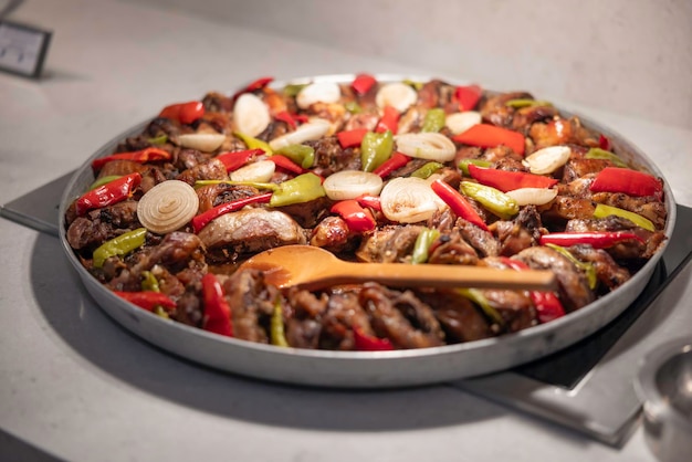 Lamb neck kebab with onions and vegetables on a tray in the hotel restaurant