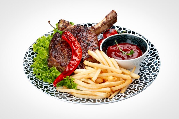 Lamb rack with fries and sauce On a white background