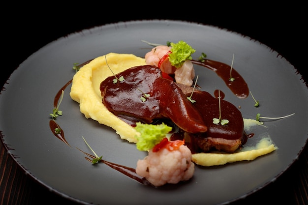 Lamb tongues with mashed potatoes on a wooden background