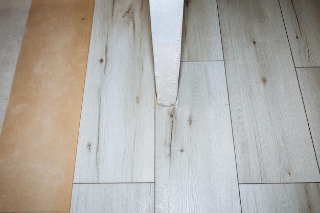 Laminate flooring in apartment Maintenance repair works renovation Restoration of wooden parquet planks indoors