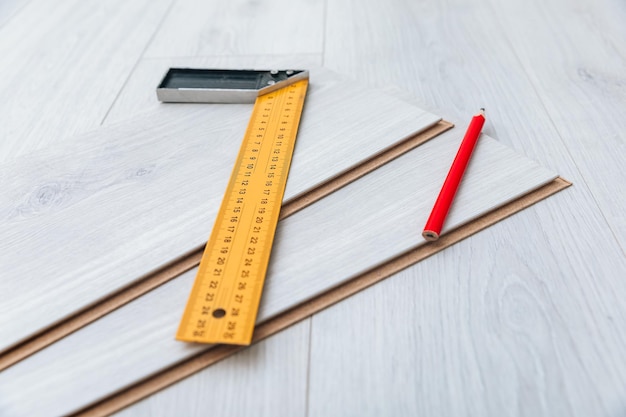 Laminate installing equipment on planks closeup