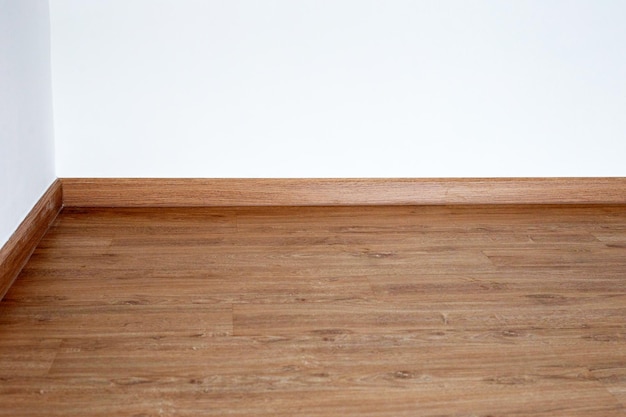 Laminate wood floor with blank white wall