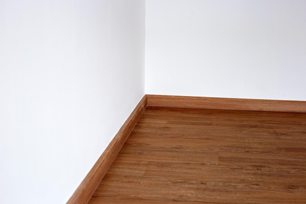 Laminate wood floor with blank white wall