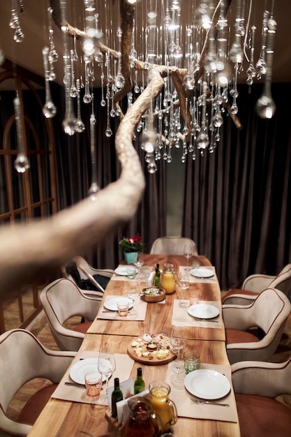 lamp made of glass with drops of water, hanging from the ceiling. restaurant interior, cozy room