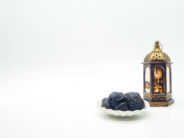 A lamp and a plate of food with a black fruit on it.