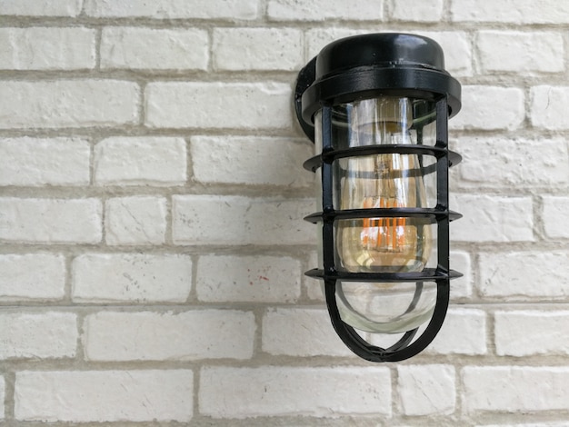 Lamp and white bricks wall background