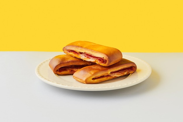 Lanche misto traditional portuguese sandwich with cheese and chorizo tasty breakfast over yellow bac