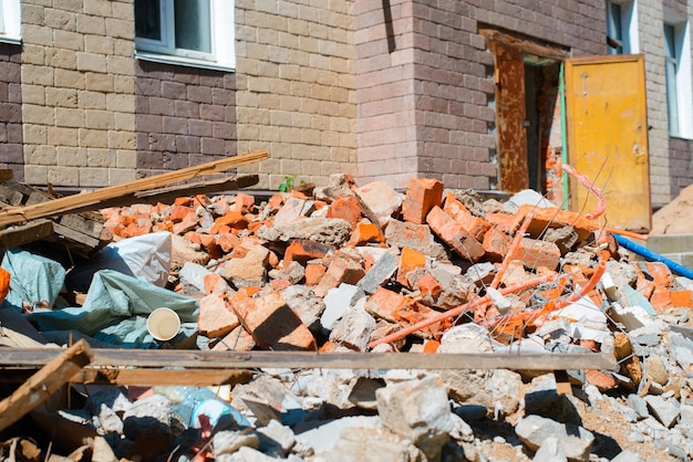 Landfill broken old bricks boards used materials on the background of a building under construction outdoors