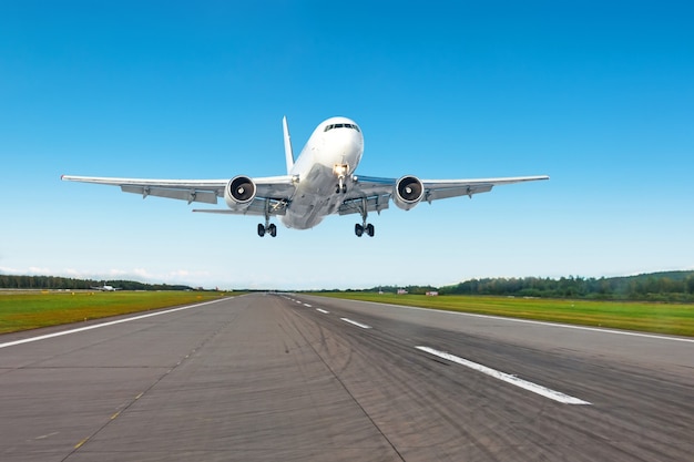 Landing aircraft on the runway at the airport, during the good weather.