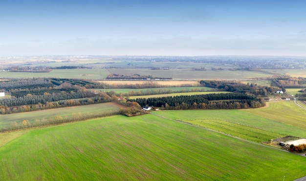 Landscape aerial view of a farm in the countryside in summer Agricultural field for farming cultivation and harvesting from above An empty piece of land for vineyards ranching and growing crop