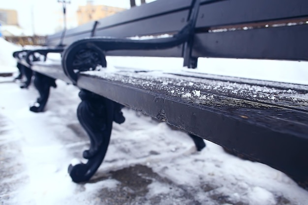 landscape bench in city park winter frost, christmas morning in the city