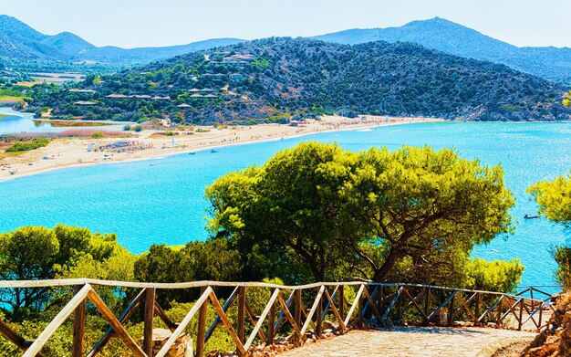 Landscape of Chia Beach and Blue Waters of the Mediterranean Sea in Province of Cagliari in South Sardinia in Italy. Scenery and nature. Mixed media.