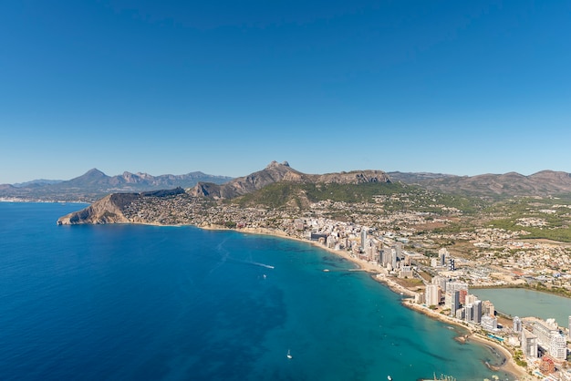 Landscape of the city of Calpe from the top of the Peñon de Ifach natural park, with clear blue skies.