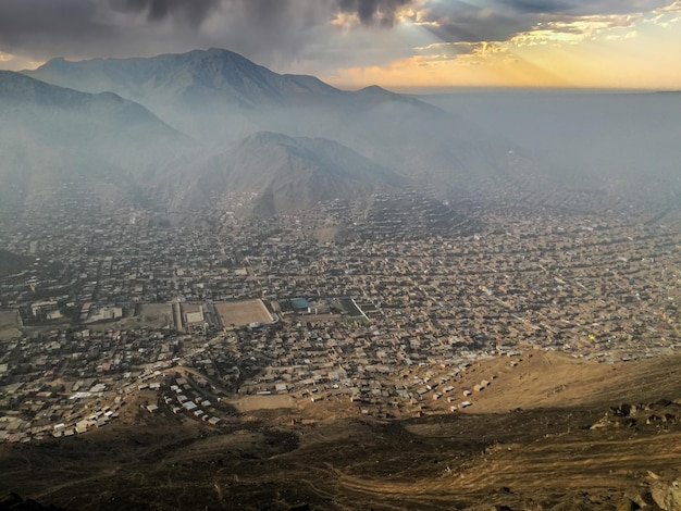 Landscape of a city between desert mountains and beautiful epic sky.