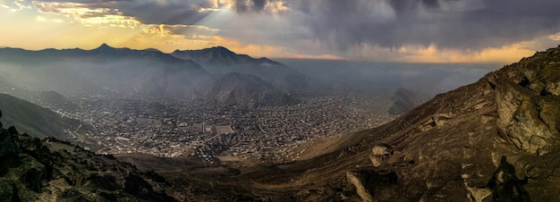 Landscape of a city between desert mountains and beautiful epic sky.